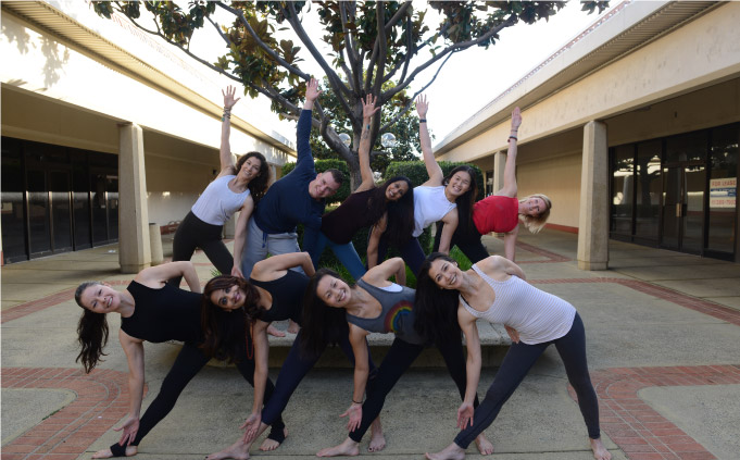 group of synchronized yoga teacher trainers